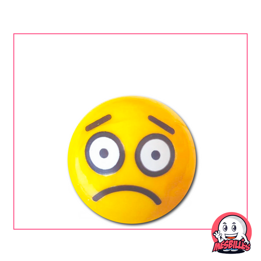Yellow Marble depicting a sad face, with large round eyes and a downturned mouth