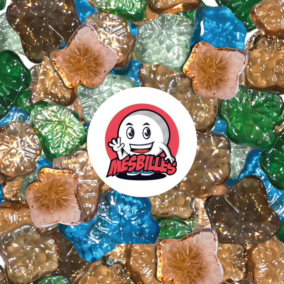Set of marbles in the shape of a maple leaf in a variety of colours (peach, green, blue, transparent), around the My-Glassmarbles Logo